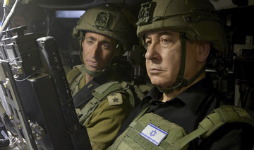 Israeli PM Benjamin Netanyahu sits in a military vehicle during a surprise visit to Israeli soldiers in Rafah, Gaza Strip.