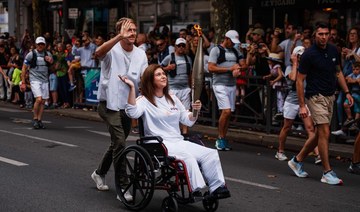 Lebanese photojournalist, wounded in Israeli strike, carries Olympic torch to honor journalists
