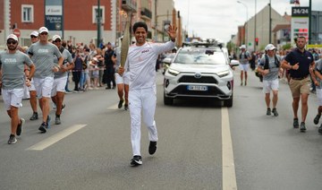 ‘An achievement for all Arabs’: PSG President Nasser Al-Khelaifi takes part in Olympic Torch Relay in Paris ahead of opening ceremony