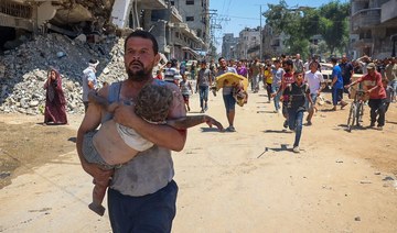 People carry children injured during Israeli bombardment as people flee at the Al-Bureij refugee camp in the central Gaza Strip 