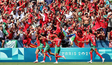 Morocco fans rush field during Olympic football opener versus Argentina. Game suspended, goal disallowed