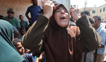 A Palestinian woman reacts following an Israeli strike, amid the Israel-Hamas conflict, at Al-Aqsa Martyrs Hospital.