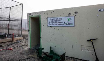 Objects are scattered in front of a shrapnel-poked wall at a sports facility a day after a rocket strike from Lebanon.