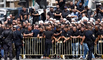 Israeli security hold back demonstrators during a visit by the Israeli prime minister.