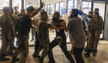 Israeli soldiers clash with right wing protesters, after they broke into the Bayt Lid army base.