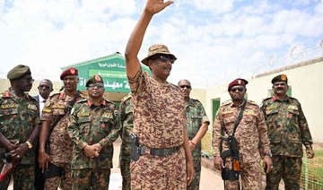 Sudan’s army chief Abdel Fattah Al-Burhan (C) waves during a graduation ceremony in Gibet near Port Sudan on July 31, 2024. (AFP