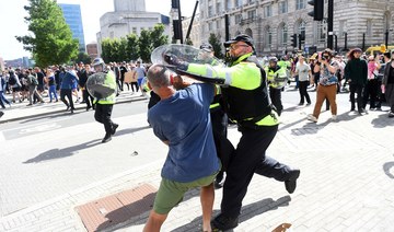 Police officers try to restrain a protester in Liverpool on August 3, 2024 during the “Enough is Enough” demonstration.