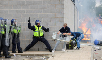 A police officer clashes with a protestor outside a hotel in Rotherham, Britain, August 4, 2024. (Reuters)