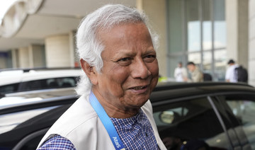 Nobel laureate Muhammad Yunus smiles upon his arrival at Charles de Gaulle’s airport in Roissy, north of Paris. (AP)