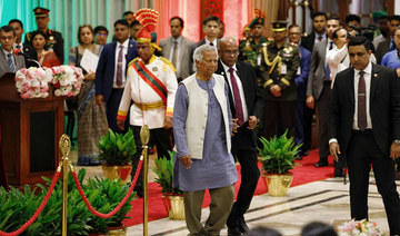 Muhammad Yunus walks off the stage after taking oath at the Bangabhaban as head of the interim government, in Dhaka, Bangladesh.