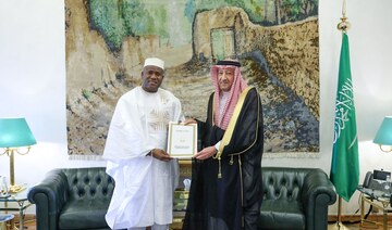 Guinea’s Minister of Planning and International Cooperation Ismael Nabe hands over the letter to Saudi deputy foreign minister.