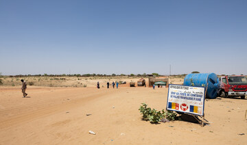 People cross the border between Sudan and Chad at the border post in Adre. (File/AFP)