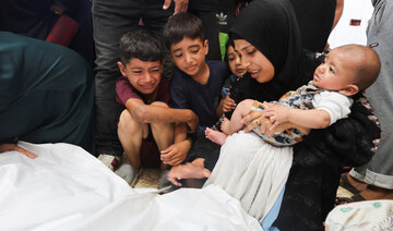 Mourners react next to the bodies of Palestinians killed in Israeli strikes at Al-Aqsa Martyrs Hospital in Deir Al-Balah.