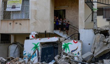 Palestinian children stand amid the destruction caused by an Israeli raid in the Nur Shams camp near Tulkarem