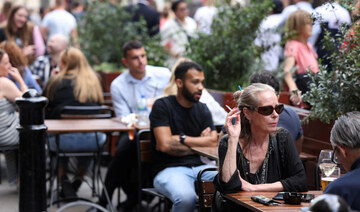 A woman smokes outside a pub in Covent Garden, London, Britain, August 29, 2024. (Reuters)