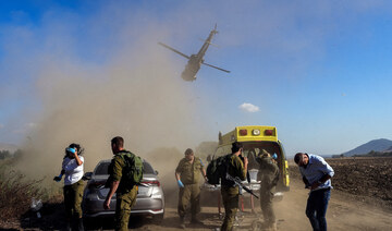 Israeli soldiers evacuate an injured man following a cross-border attack from Lebanon into Israel.