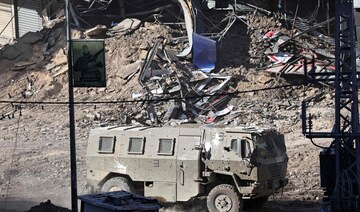 An Israeli armored vehicle drives along a devastated street in Jenin in the occupied West Bank on September 4, 2024.