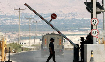 A man walks at a barrier, at the Allenby Bridge Crossing between the West Bank and Jordan.