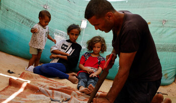 Gaza carpenter crafts wooden sandals for daughters as war rages