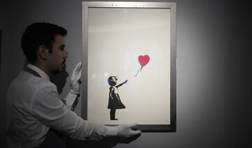 Two men charged with stealing a famous Banksy image from a London art gallery