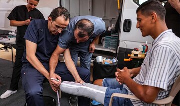 A man with an above-the-knee amputation is fitted with a new prosthetic limb at a Jordanian field hospital in Khan Yunis.