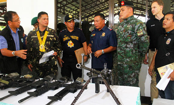 Peace commitment: Philippines' MILF group returns 16 guns of slain cops