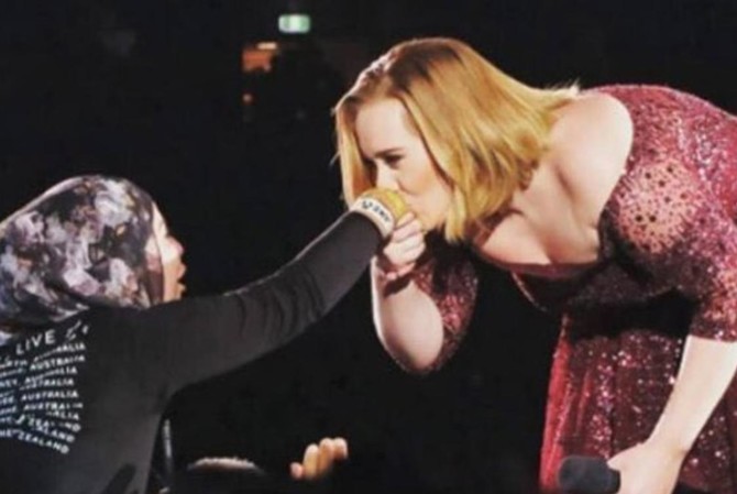 Adele stirs up social media after kissing hijab-wearing fan in Australia