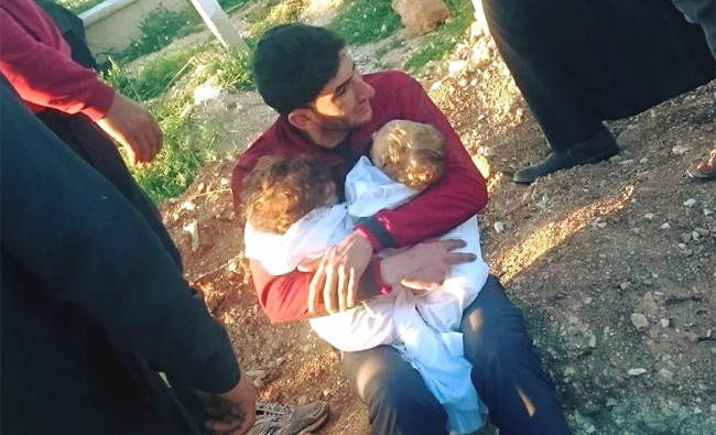 A father bids farewell to twin toddlers after Syria attack