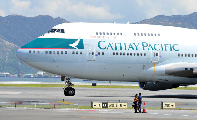 Plane skids off Hong Kong runway in heavy rain