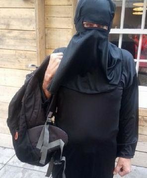 Armed police stop man in a burqa in British city center