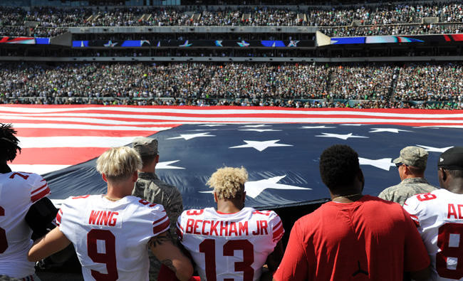 NFL Players Lock Arms, Kneel During National Anthem to Protest Trump