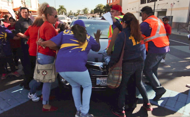 Six people injured as man drives car into US immigration rally