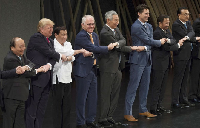 In Asia, Trump briefly baffled by group handshake