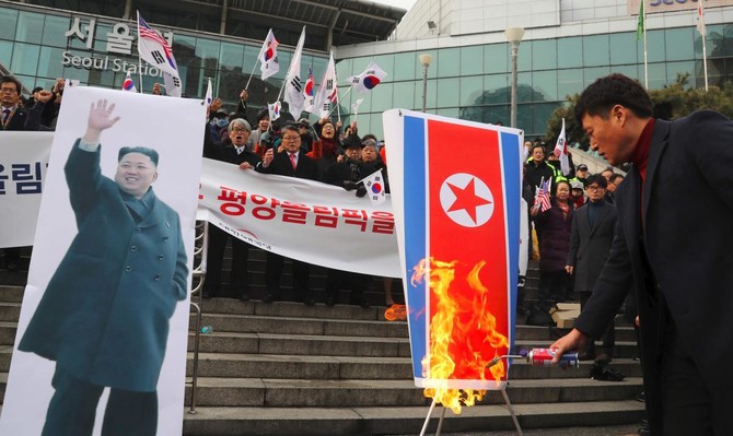 Activists rip North Korean leader’s photo in Olympic protest