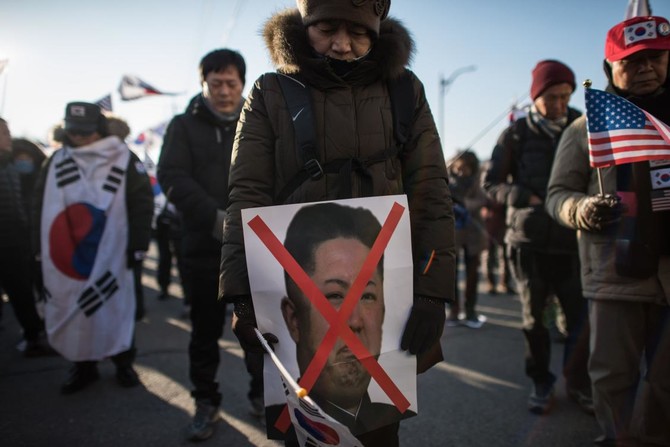 Angry South Koreans protest as ship from North carrying Olympians docks at Donghae City