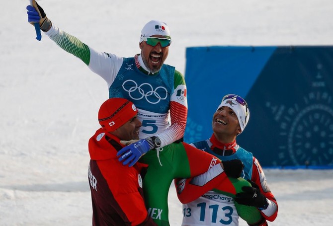 Arab history-maker Samir Azzimani carries fellow skier over line