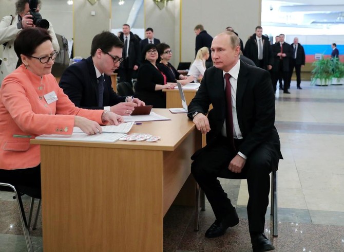 Putin on track for commanding win as Russians troop to polls