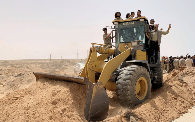 Libyan security officers stand on a truck during the re-opening of the cross road across the frozen frontline between east and west in Libya. (Reuters/File Photo)