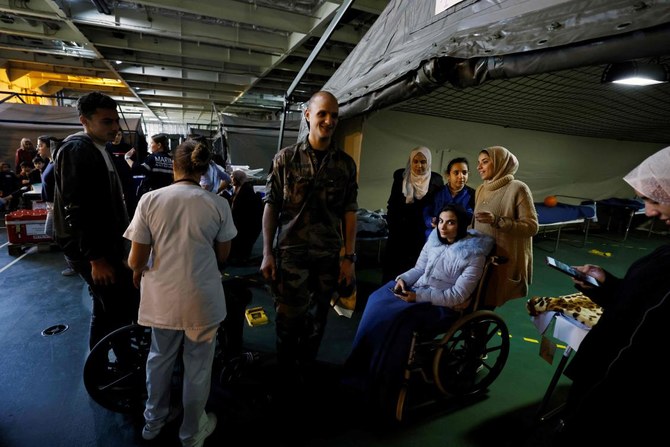 A wounded Palestinian woman on a wheelchair looks on onboard the French LHD Dixmude military ship, which serves as a hospital, as it docks at the Egyptian port of Al-Arish on January 21, 2024. (AFP)