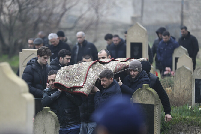 Mourners carry the body of 13-year-old Mahammadali Eganov in Baku on Saturday after he was killed in the Azerbaijan Airlines plane crash near the Kazakh city of Aktau. (Reuters)