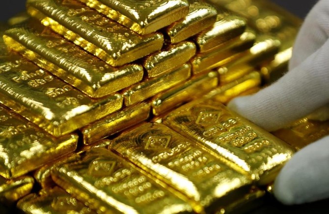 Gold slips to 1-year low as US dollar firms