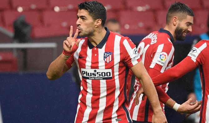 Suarez double fires Atletico clear at La Liga summit