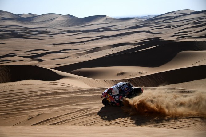 Toyota’s driver Nasser Al-Attiyah of Qatar and his co-driver Mathieu Baumel of France compete during Stage 2 of the Dakar Rally 2021 between Bisha and Wadi Ad-Dawasir in Saudi Arabia, on January 4, 2021. (AFP)