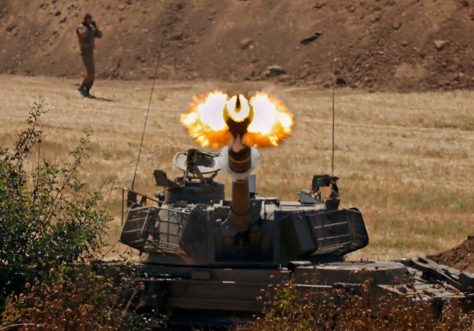 Israeli soldiers fire a 155mm self-propelled howitzer towards the Gaza Strip from their position along the border in the southern Israeli city of Sderot on May 20, 2021. (AFP)