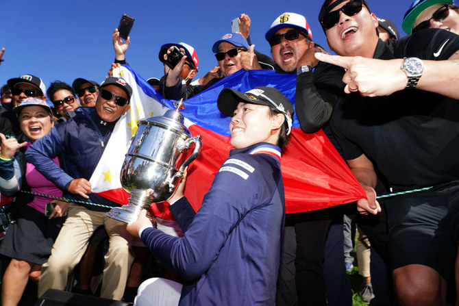 Yuka Saso hoists the US Open trophy with a group of spectators after beating Nasa Hataoka in the final round of the US Women's Open golf tournament on June 6, 2021 in San Francisco. (Kyle Terada-USA TODAY Sports)