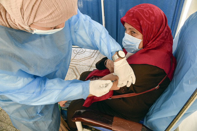 A health worker administers a dose of the Oxford AstraZeneca COVID-19 coronavirus vaccine at a walk-in vaccination centre in the Bab El-Oued district of Algeria's capital Algiers on June 7, 2021. (AFP)