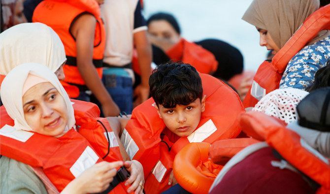 Migrants wait in a boat to be rescued by the crew of the German NGO migrant rescue ship Sea-Watch 3 in international waters off the coast of Libya, in the western Mediterranean Sea, July 30, 2021. (REUTERS)