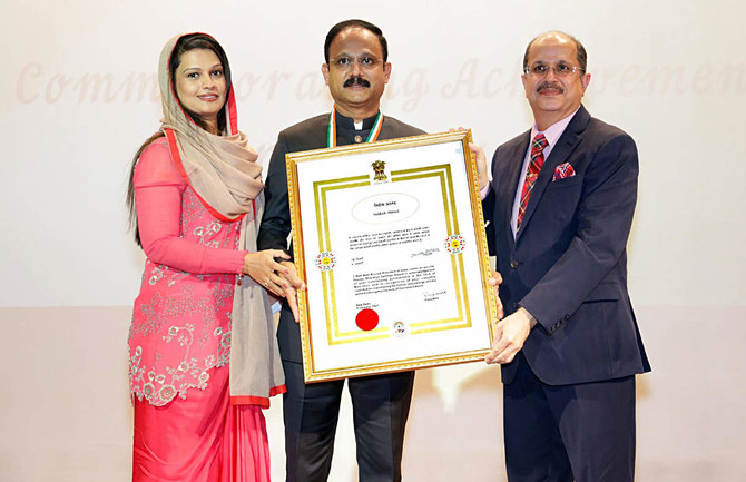 Indian Ambassador Dr. Ausaf Sayeed presents the award to Eram Group Chairman Dr. Siddeek Ahmed, center, in Riyadh. On the left is Dr. Ahmed’s wife Nushaiba. (Supplied)