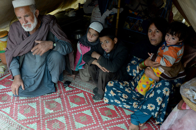 Afghan refugee Gul Pari (2nd R) sits with her family in a tent on the outskirts of Jalalabad. (AFP/File Photo)