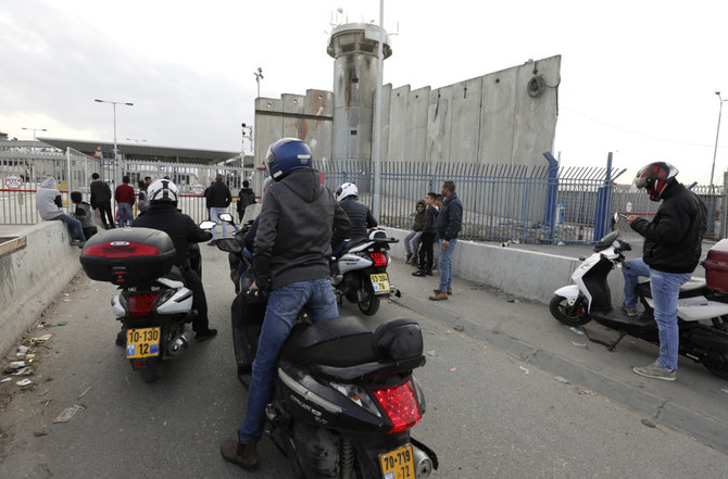  Palestinian cyclists wait at the temporarily closed Qalandia checkpoint on the crossing between the West Bank city of Ramallah and Israeli-occupied east Jerusalemon on December 7, 2020. (AFP)